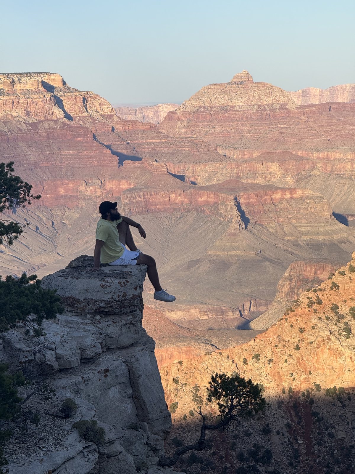 Dejan sitting near the Grand Canyon while traveling